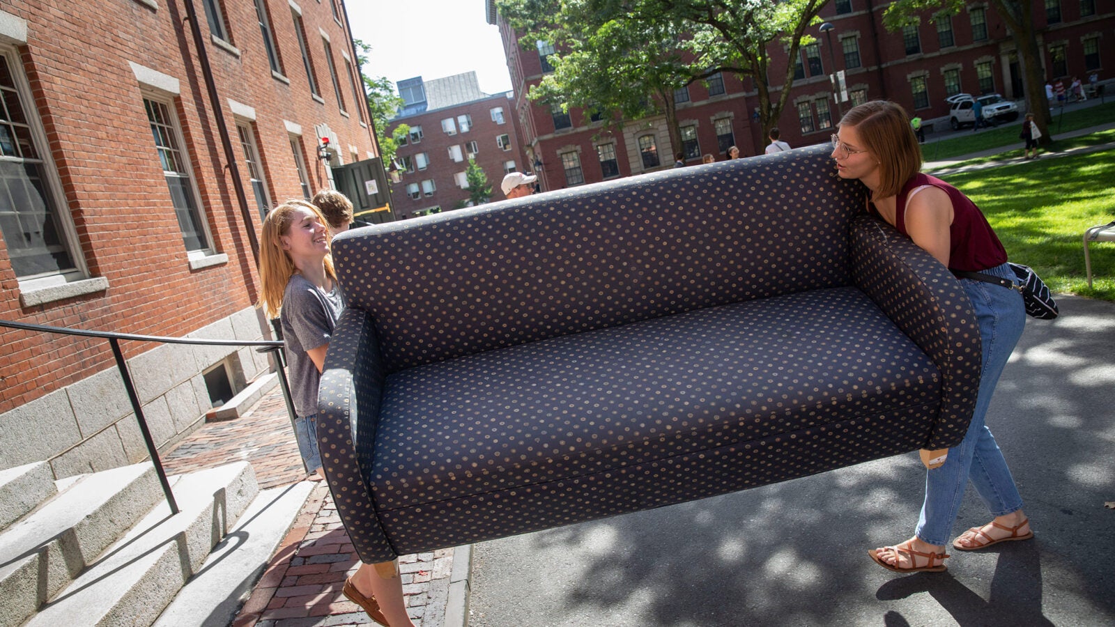 Students carrying a couch