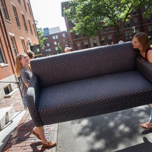 Students carrying a couch