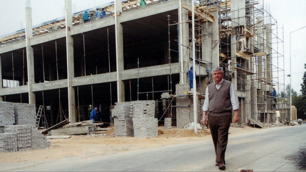 Max Essex walks past the Botswana-Harvard HIV Reference Laboratory under construction.