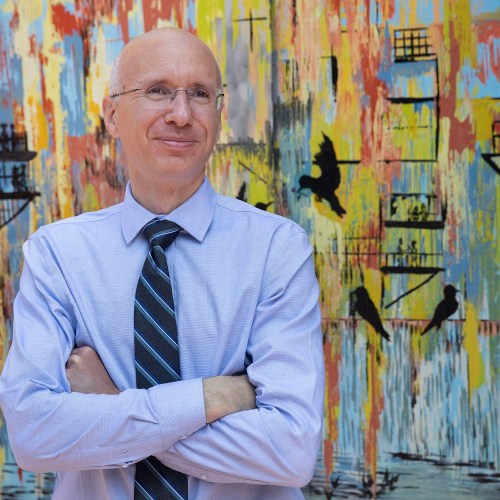 Aaron Bernstein standing in front of art