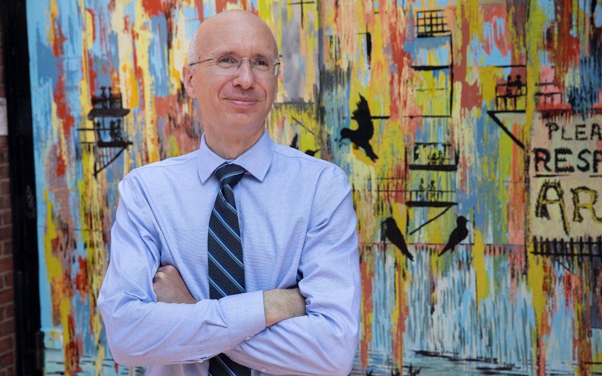 Aaron Bernstein standing in front of art