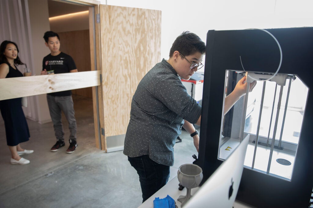 Kat Nakaji, Production & Technical Specialist shows 3D printing during ArtLab Open House