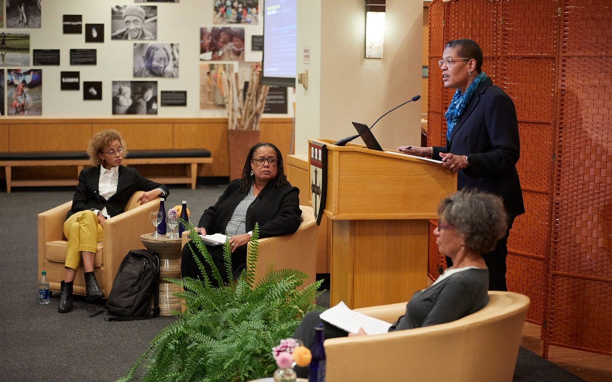 Harvard Chan School Dean Michelle A. Williams (podium) addressed the audience at the “400 Years of Inequality" event. Linda Villarosa (from left), Evelynn M. Hammonds, and Mary Bassett shared in the discussion.