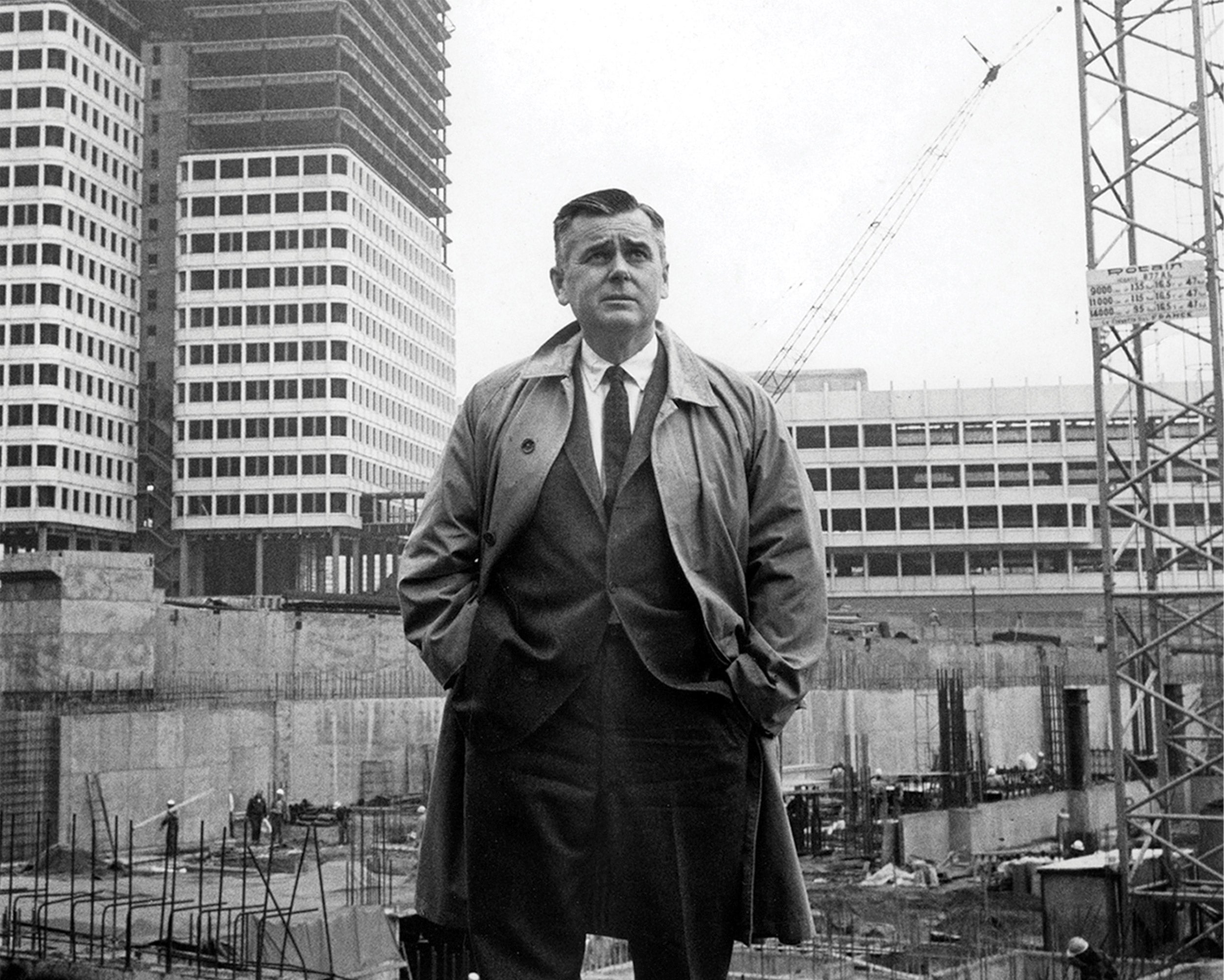 Ed Logue standing in front of Government Center construction