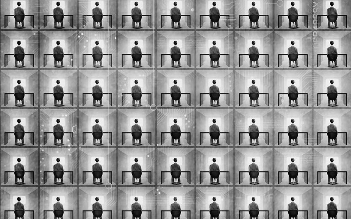 Person sitting at a desk in a black and white grid