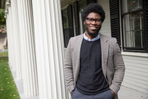 Professor standing with his hands in his pockets and smiling