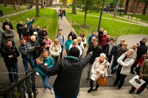 Rachel Gilchrist faces tour group in Harvard Yard.