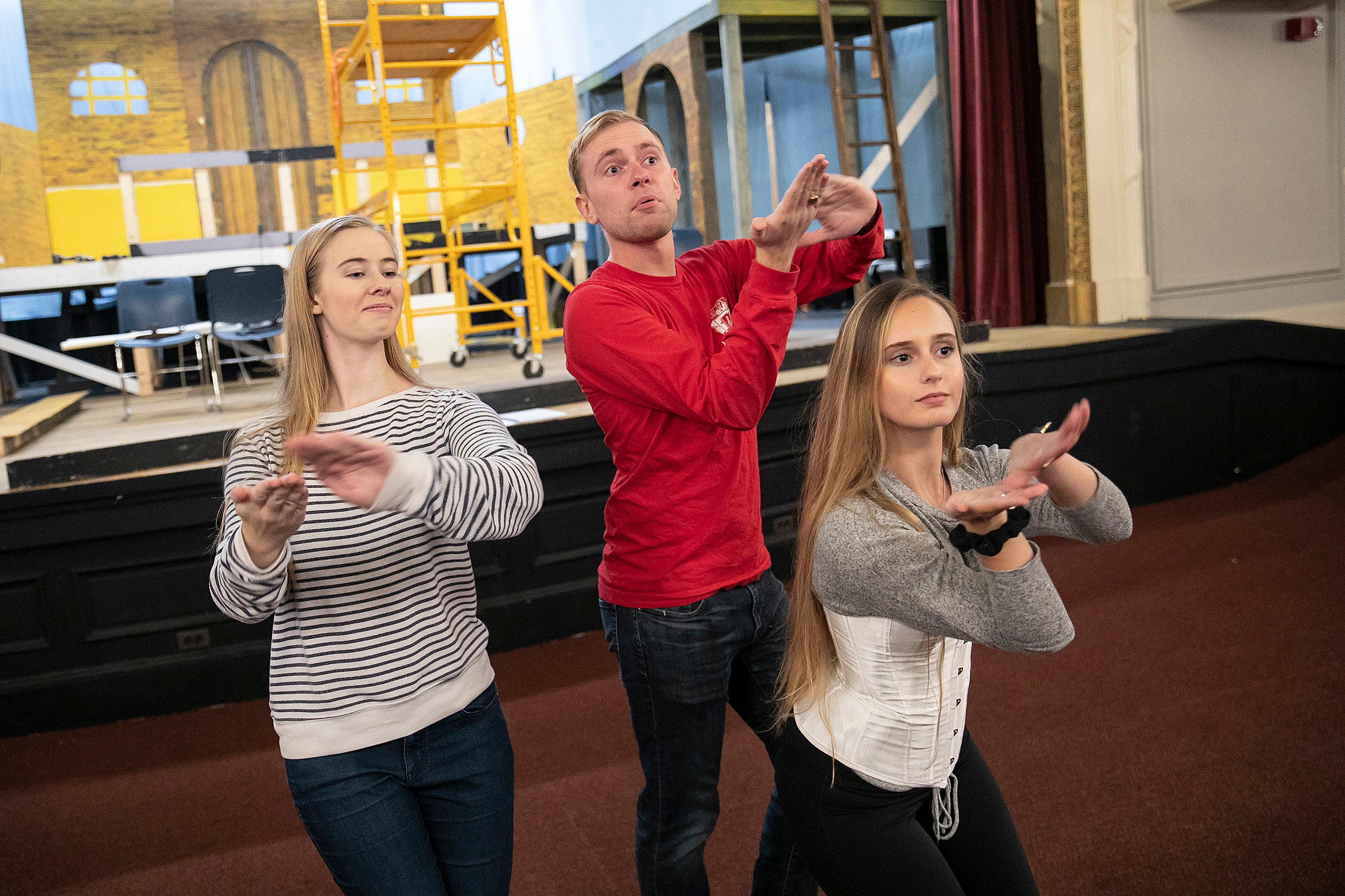 Three cast members pose during rehearsal