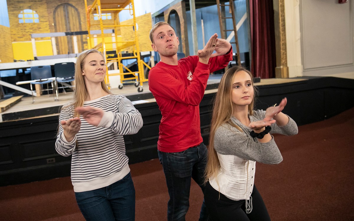 Three cast members pose during rehearsal