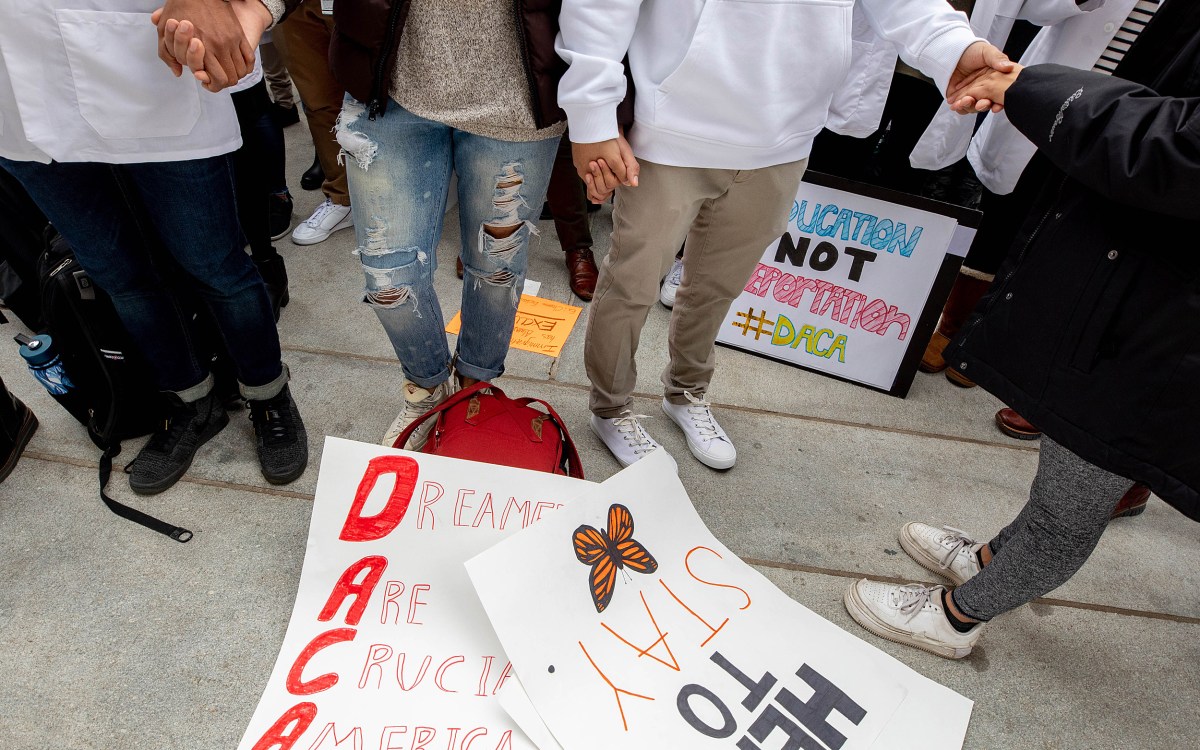 People holding hands over posters