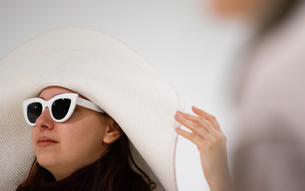 Allie Jeffay wears a large, white sun hat and sunglasses.