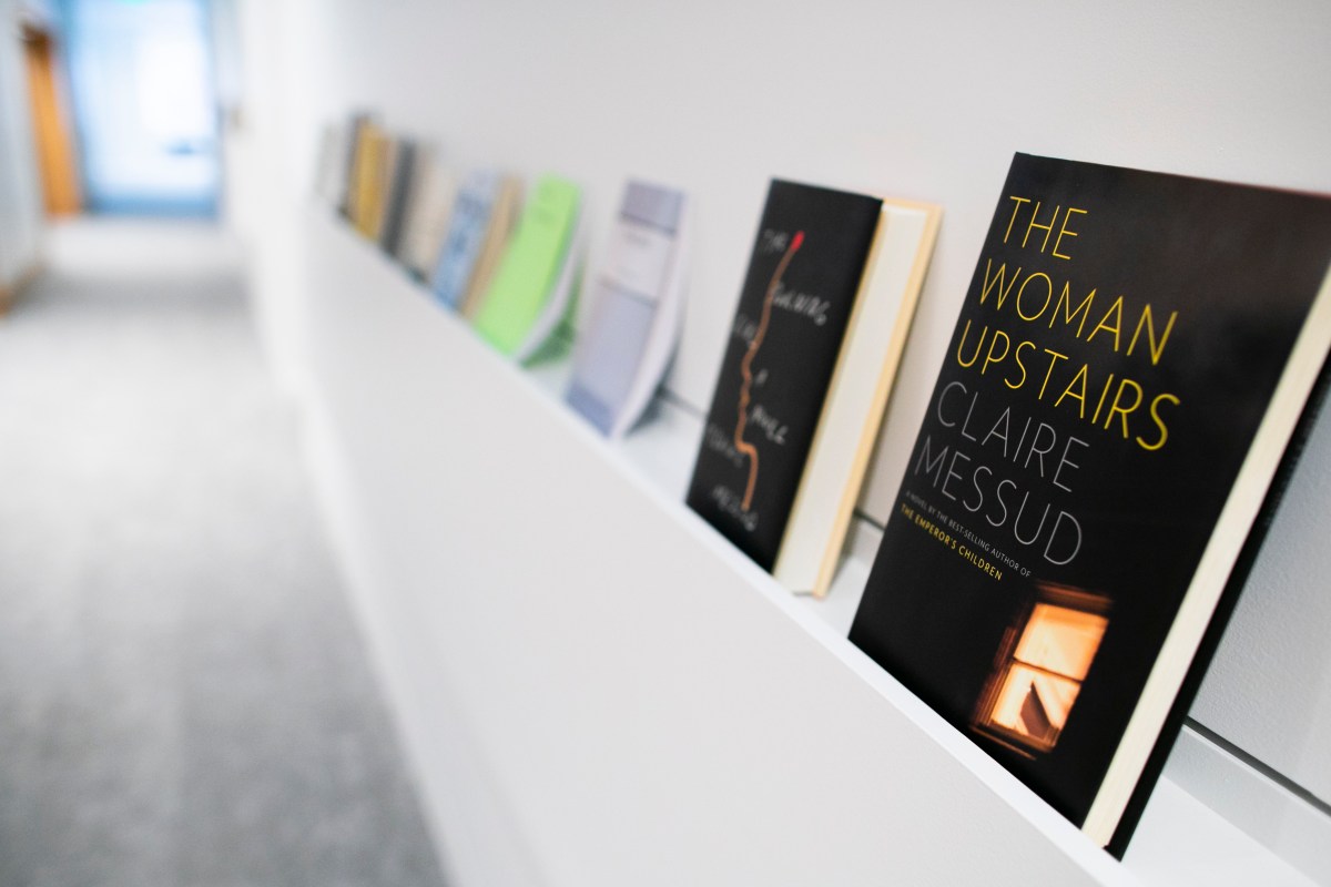 A row of books lines a shelf in the Department of English's creative writing program in Lamont Library.