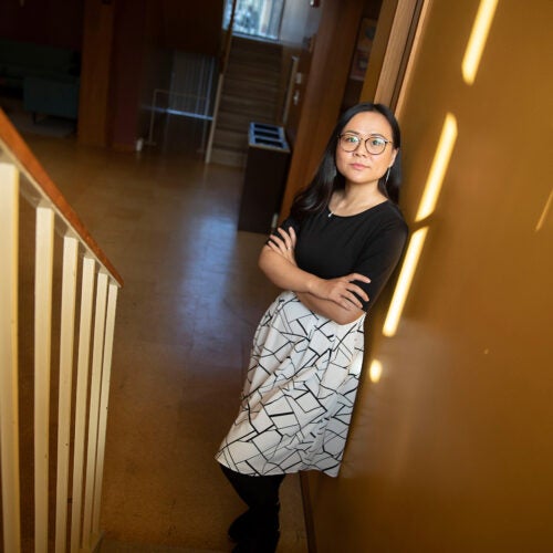 Asian woman standing in stairwell.
