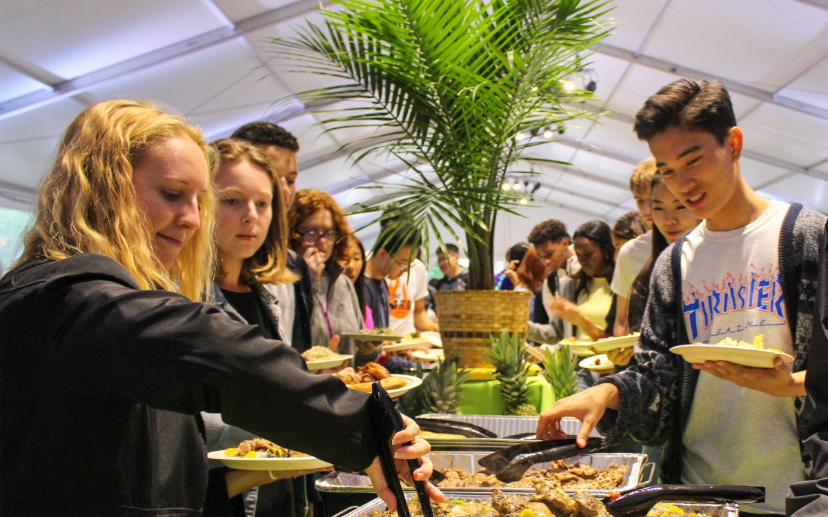 Taste of the Islands food bar with students lining yo