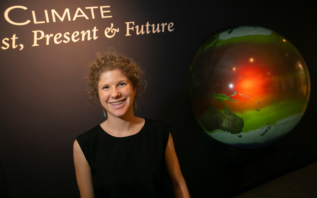 Tamara Pico in front of an image of the Earth.