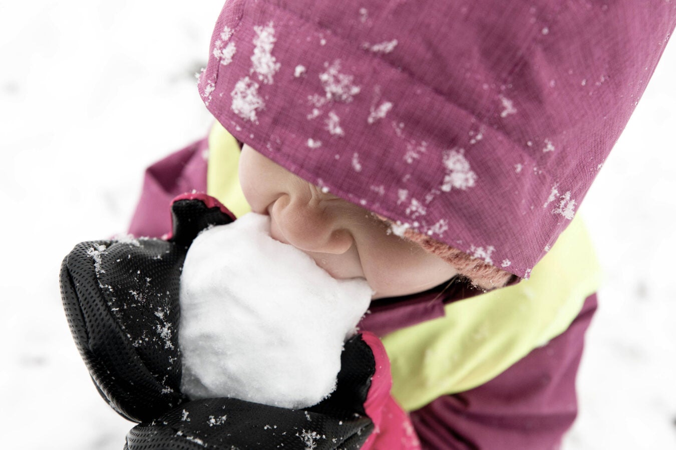 A child eats homemade snow cones on Peters Hill.