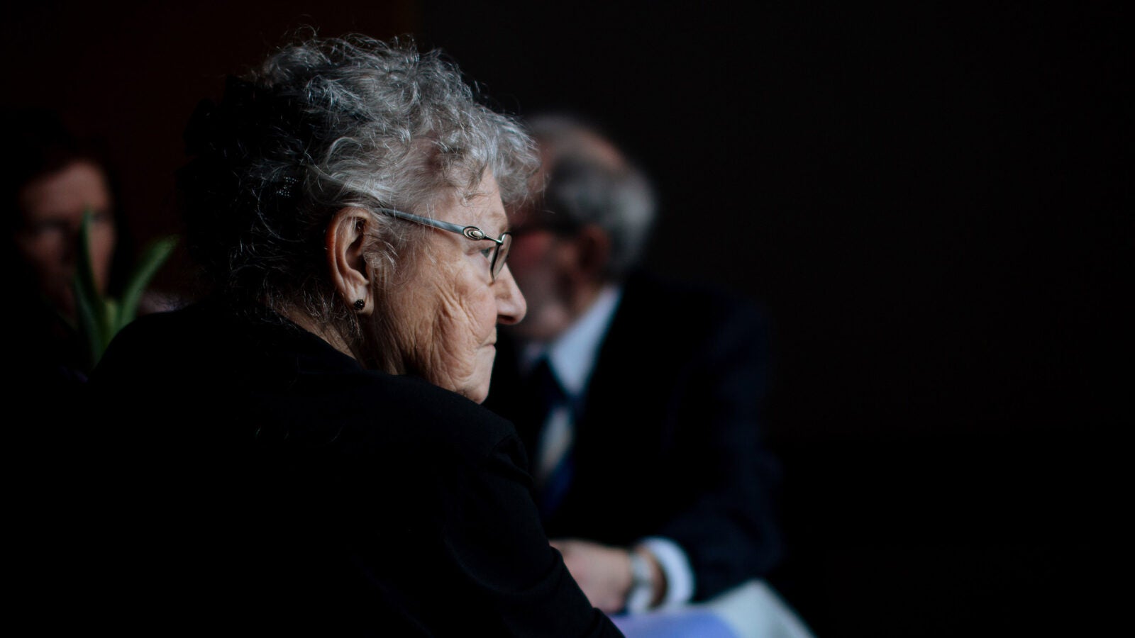 Elderly woman sitting.