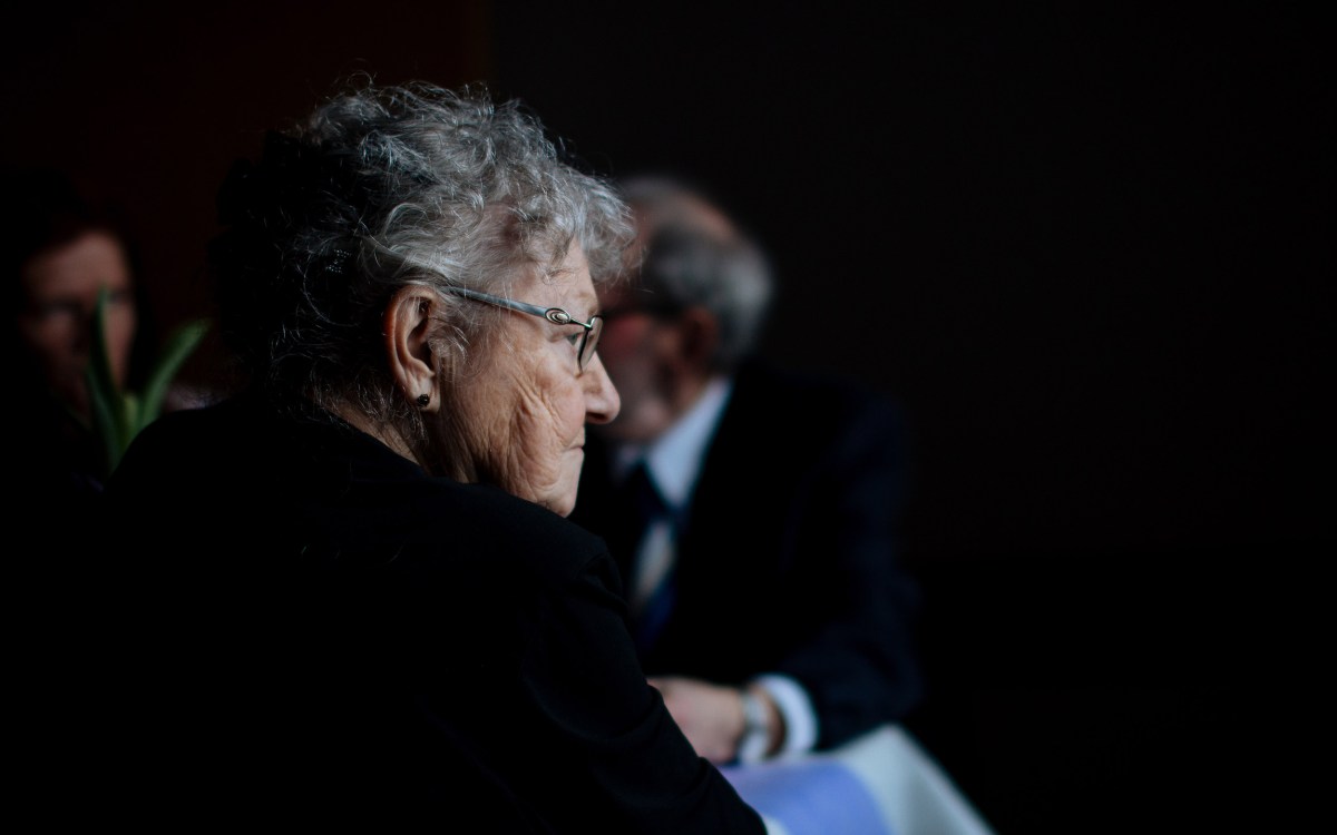 Elderly woman sitting.