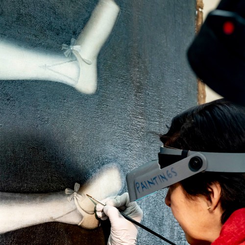 Retouching the shoe on the painting.