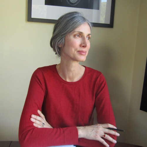 Author at desk with manuscript.