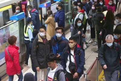 People with masks on at a Chinese metro station.