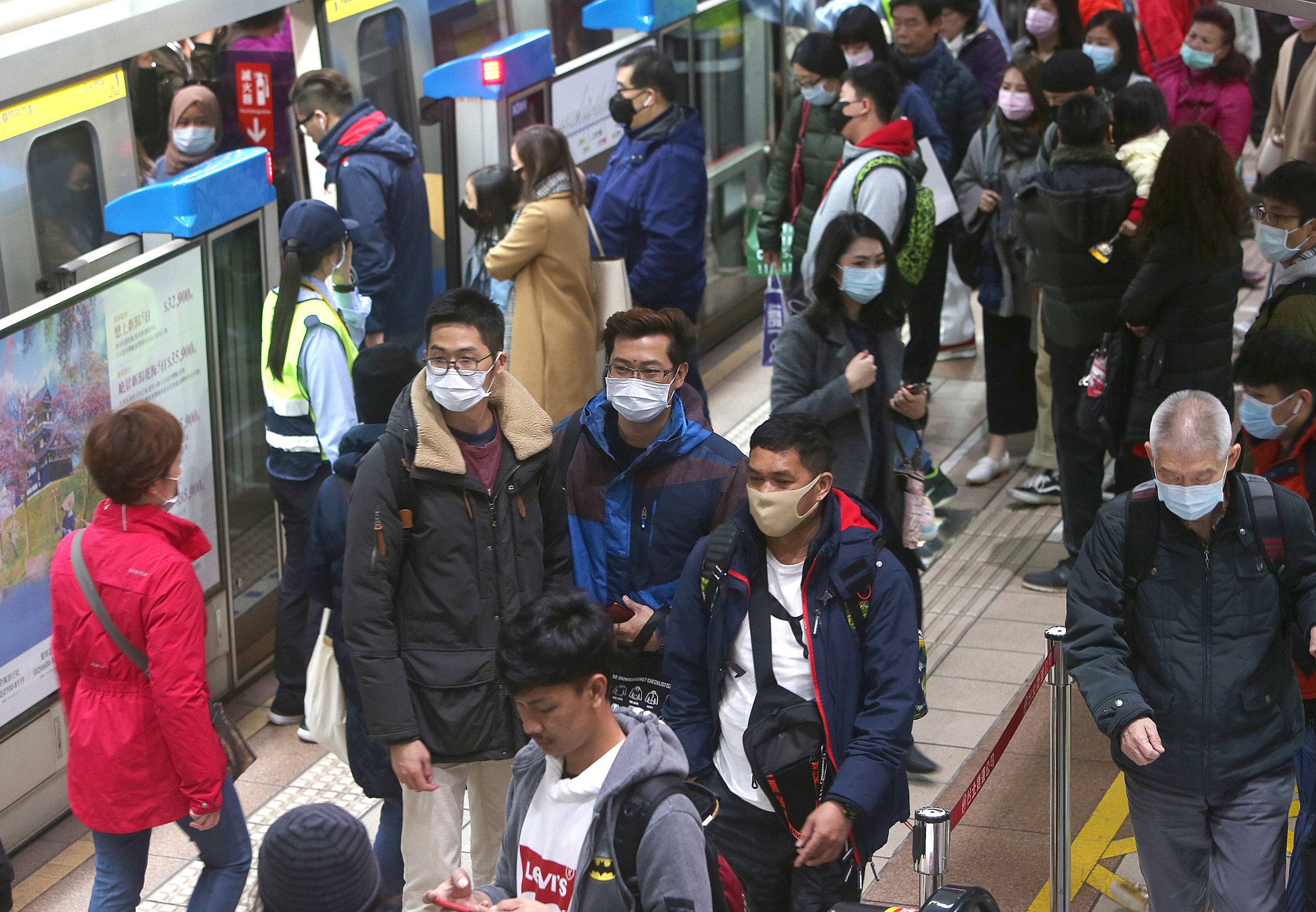 People with masks on at a Chinese metro station.