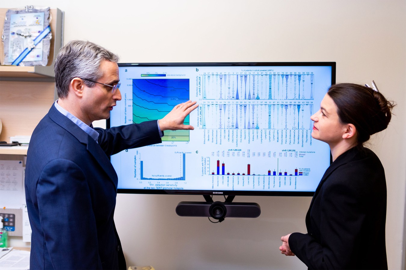 Two scientists looking at a computer screen.