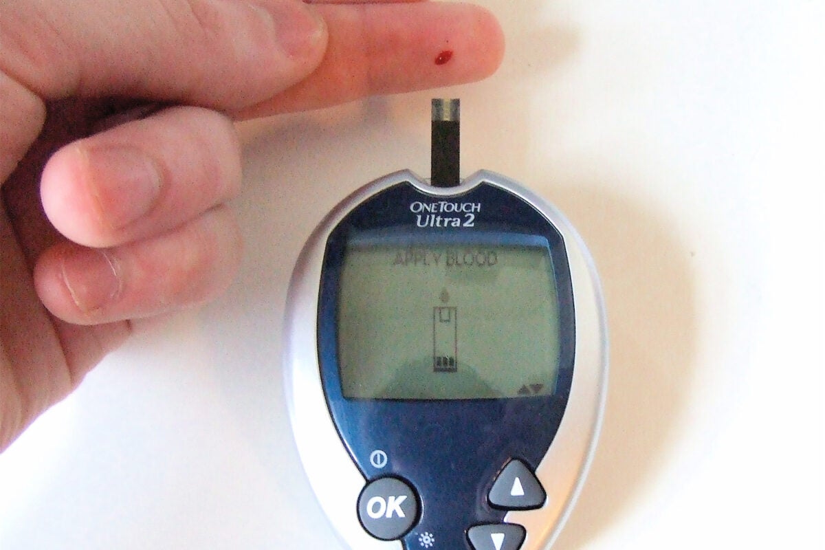 Checking glucose levels on finger.