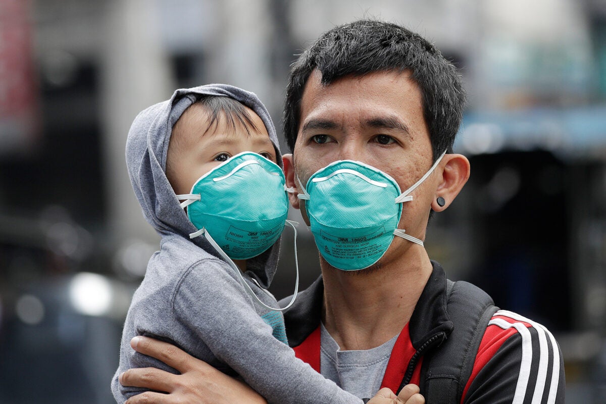 Adult and child wearing flu masks.