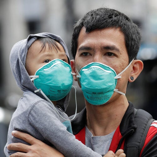 Adult and child wearing flu masks.