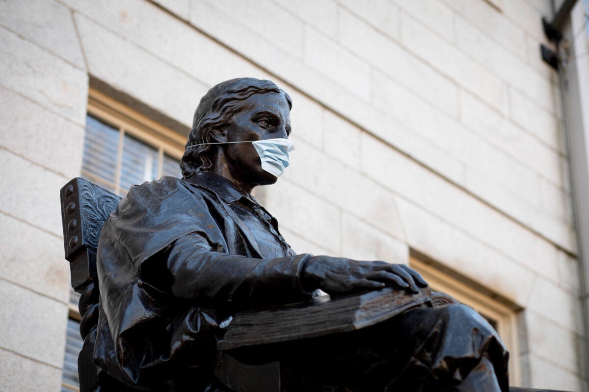 John Harvard Statue with mask on.
