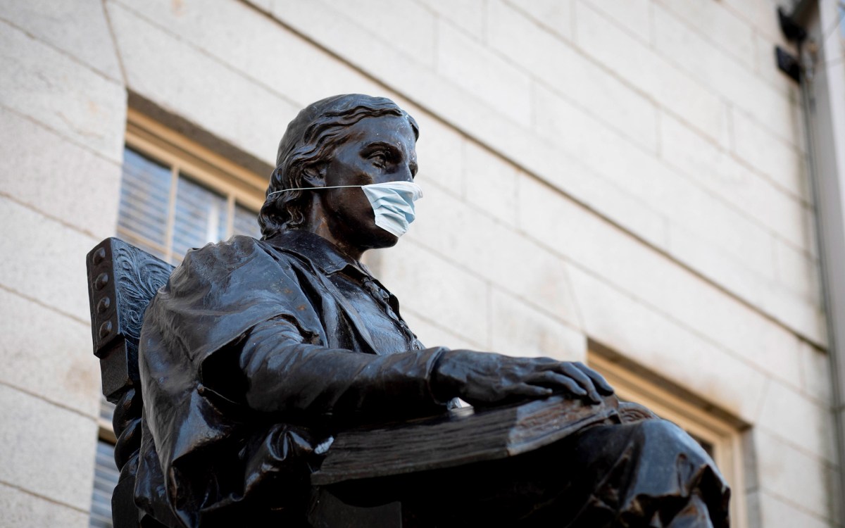 John Harvard Statue with mask on.