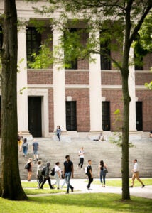 Students flow in and out of Widener Library.