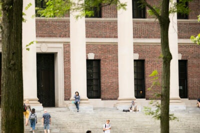 Students flow in and out of Widener Library.