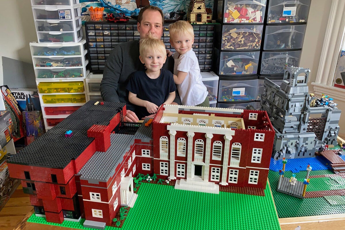 Jonathan Savilonis and sons Julius and Lysander with their LEGO model of Harvard's Music Building.