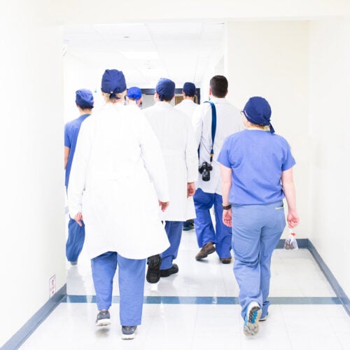 Doctors and nurses walking down a corridor.