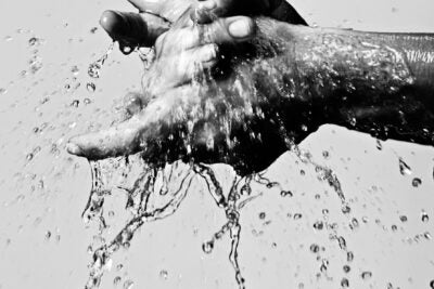 Hands being washed.