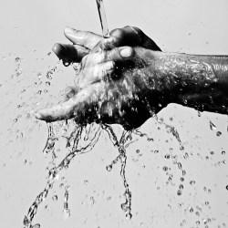 Hands being washed.