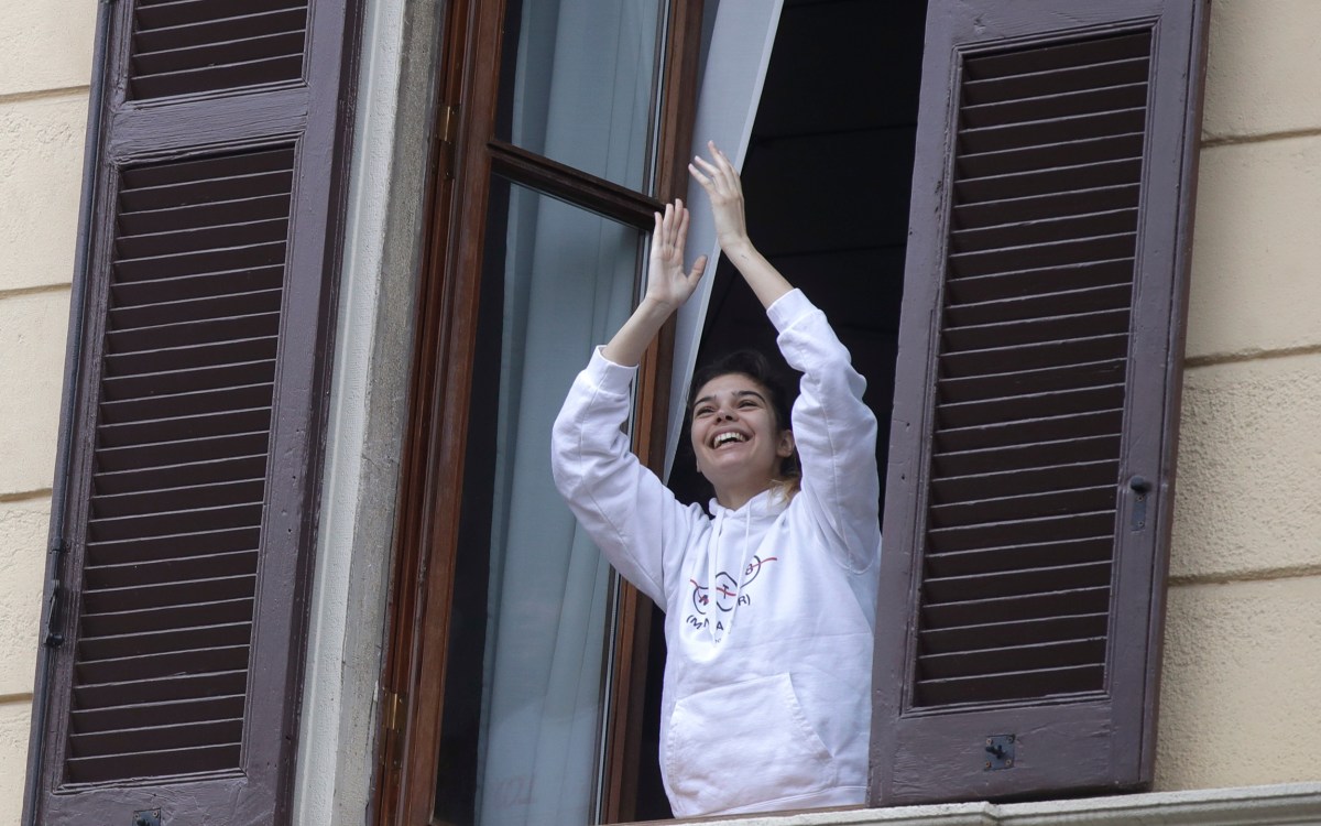 Smiling woman in a window.