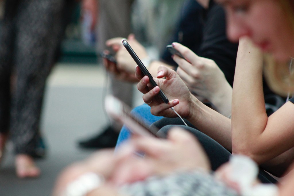 People looking at smartphones.