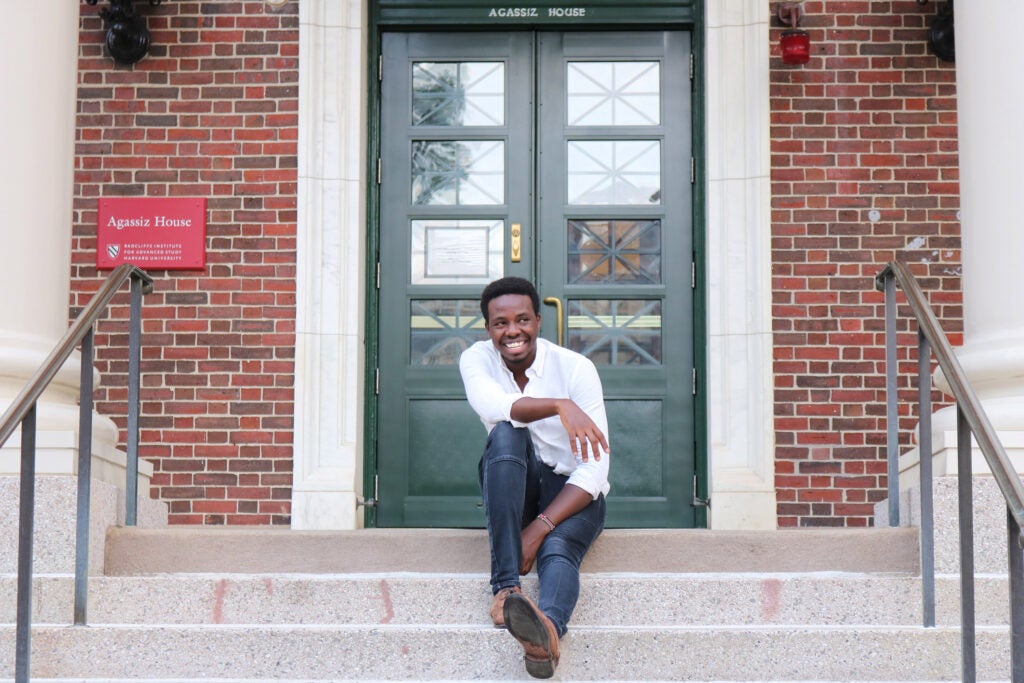 Billy Koech sitting on stairs at Harvard.