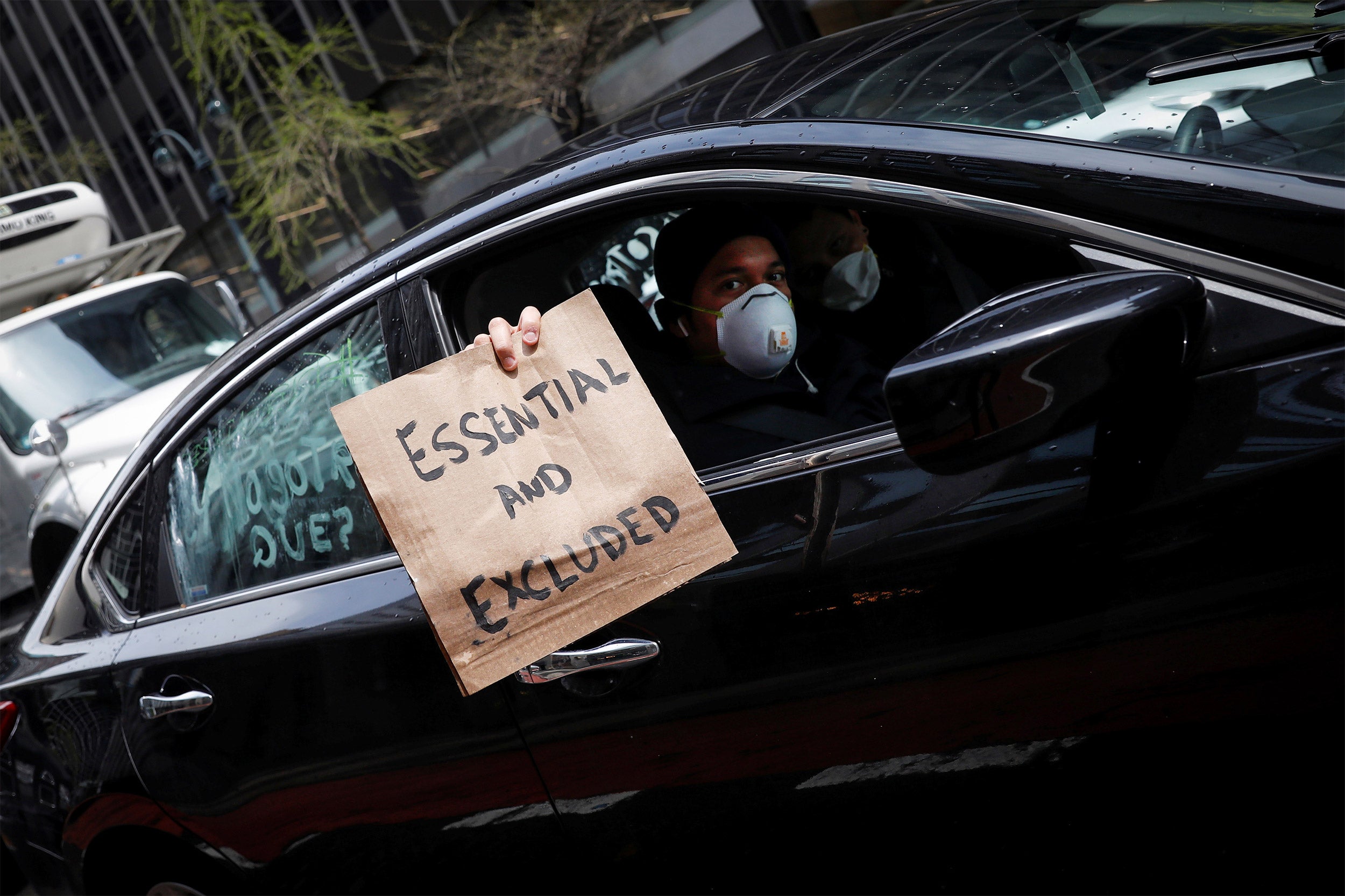 Man holding a protest sign from car.