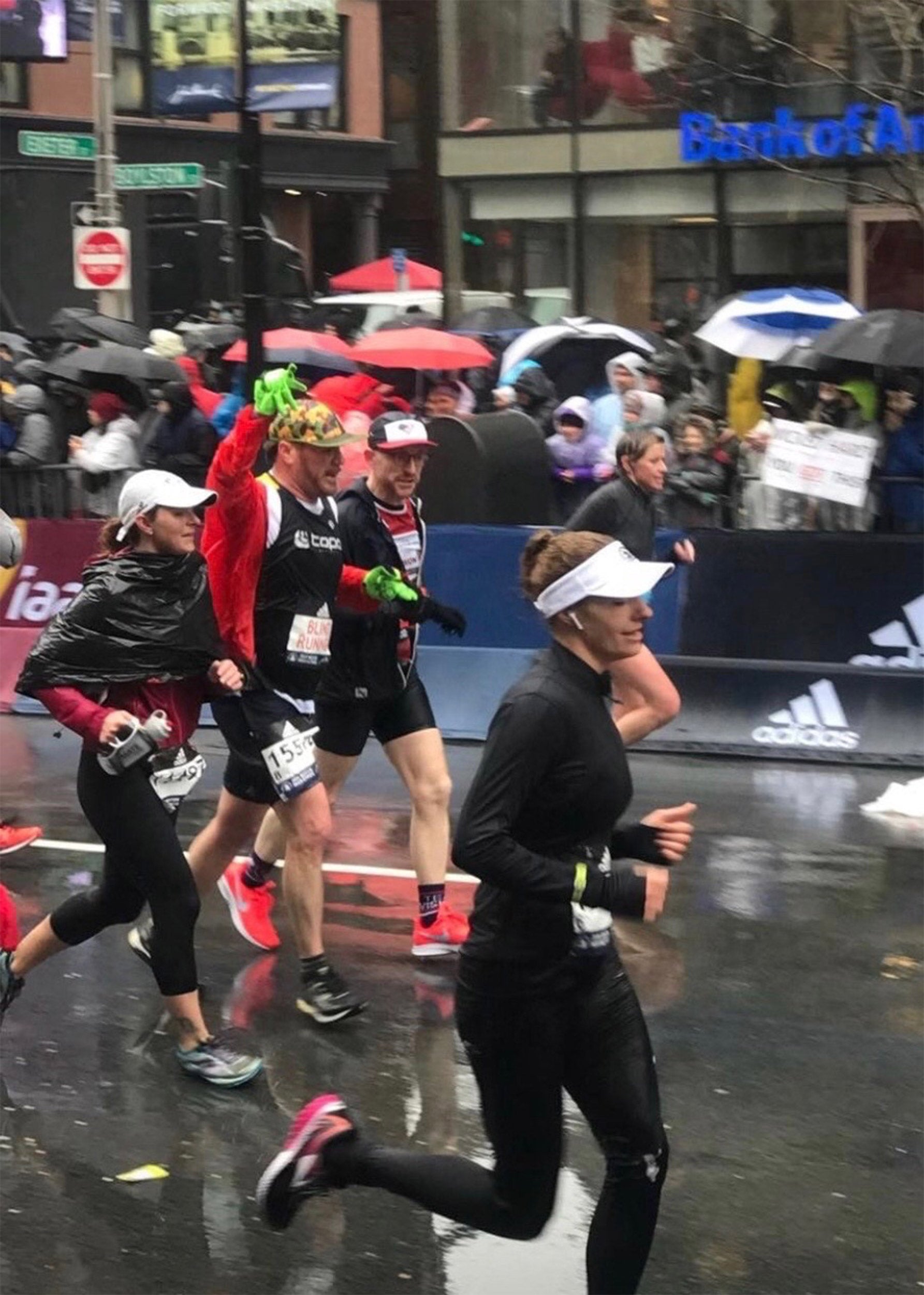 Kirstin Woody Scott and Kyle Robidoux running to the Boston finish line in 2018.