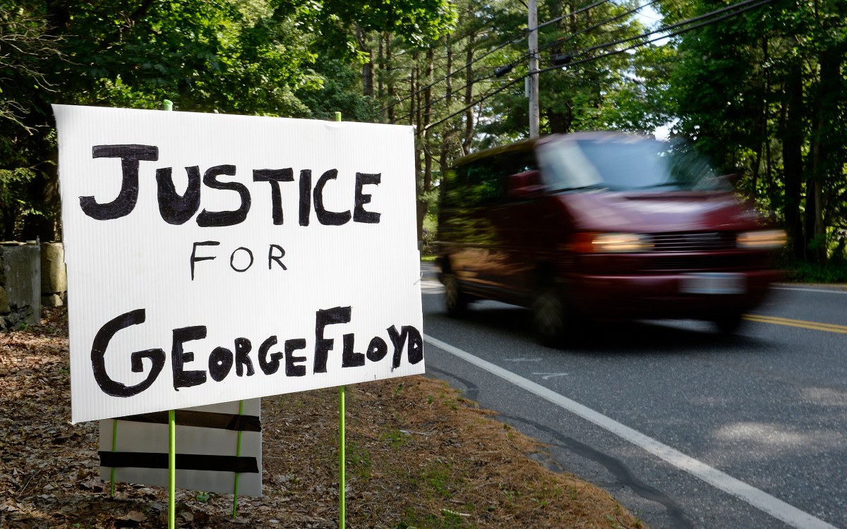 A sign reads, Justice for George Floyd.