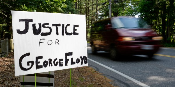 A sign reads, Justice for George Floyd.