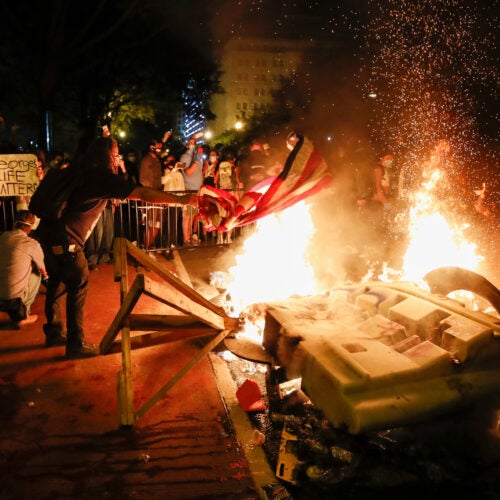 Fire burns during protest of police killing of George Floyd outside White House.