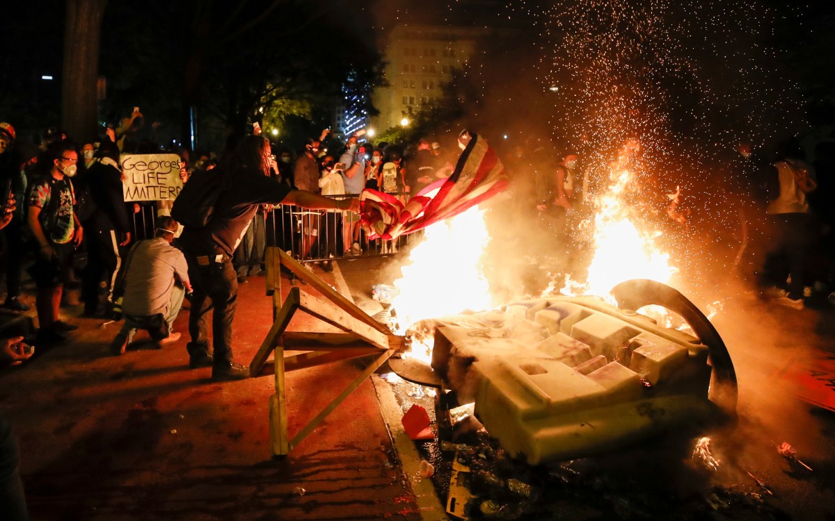 Fire burns during protest of police killing of George Floyd outside White House.