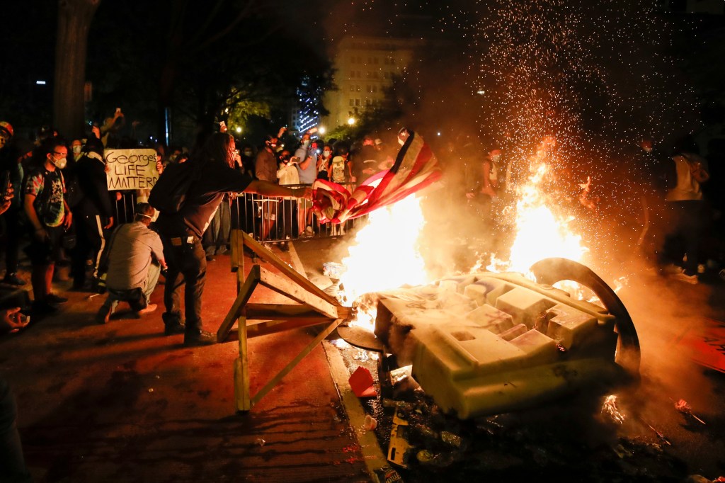 Fire burns during protest of police killing of George Floyd outside White House.