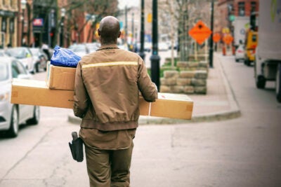 A delivery man with pacakges.