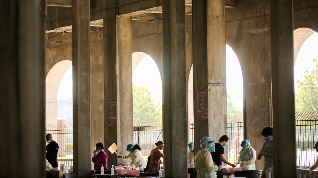 COVID-19 testing takes place in the open-air concourse of Harvard Stadium.